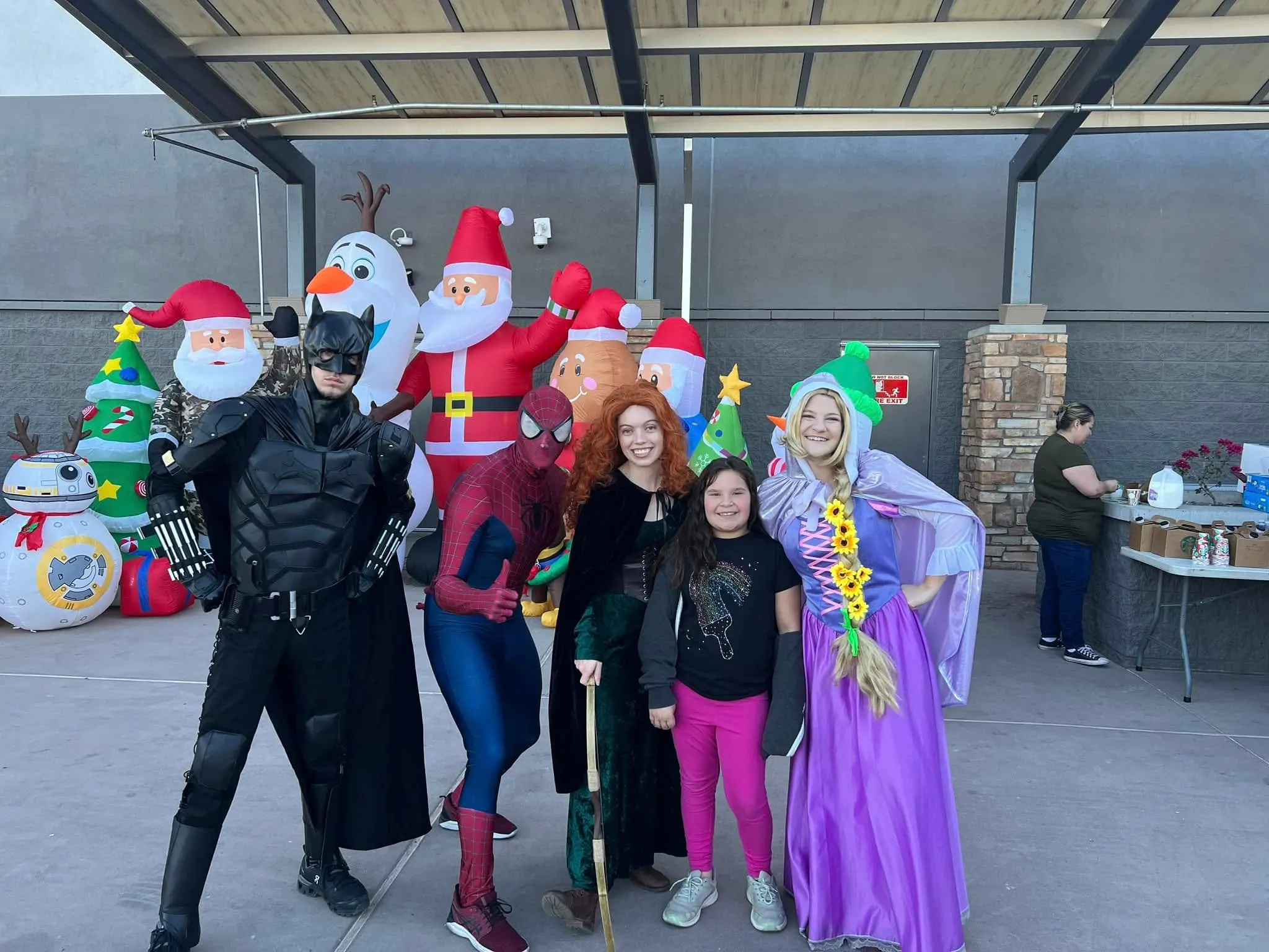 Kearny community heroes at a holiday event — Batman, Spider-Man, princesses and families