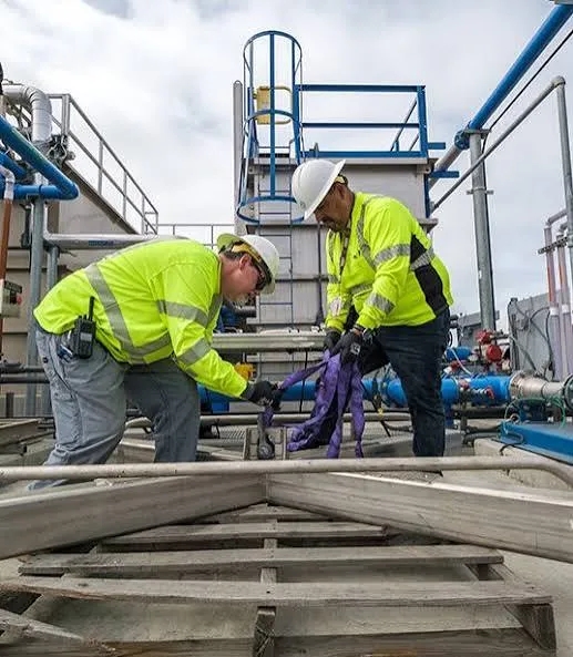 Kearny wastewater plant workers repairing equipment